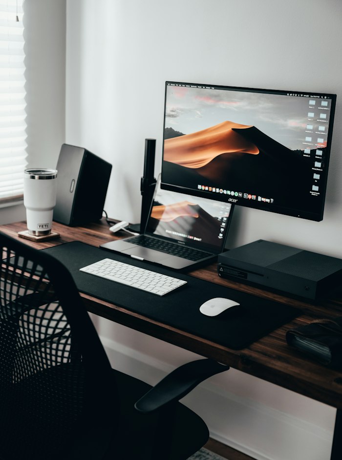 Home office desk with a laptop and monitor