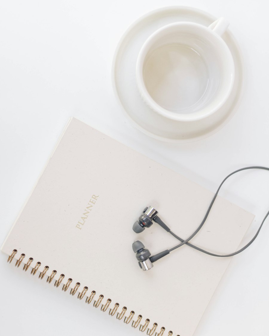 Notebook and coffee mug on a white desk