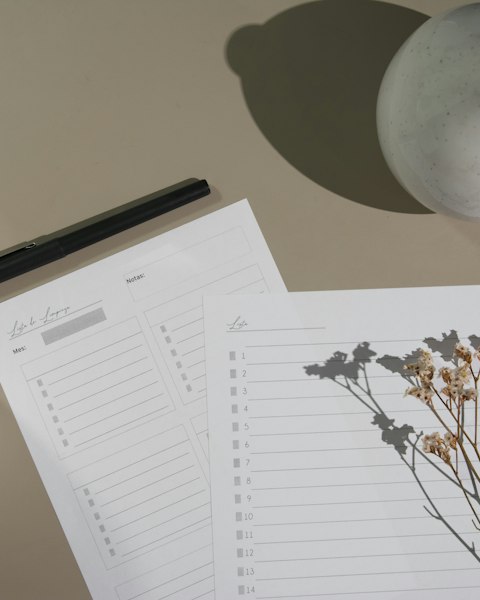 Neutral flat lay of a planner and dried flowers